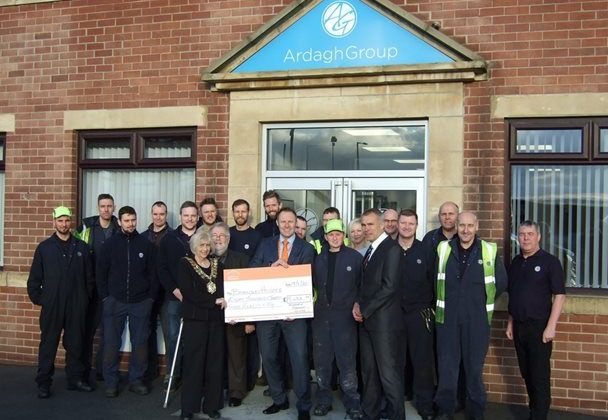 Photo of the team from the Armagh Group presenting a cheque to Barnsley Hospice in memory of their colleague