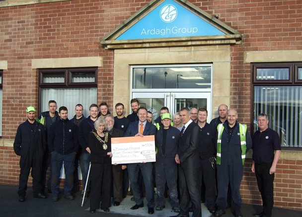 Photo of the team from the Armagh Group presenting a cheque to Barnsley Hospice in memory of their colleague