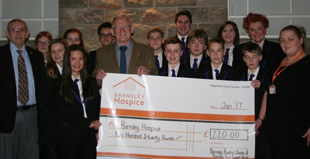 young people presenting cheque