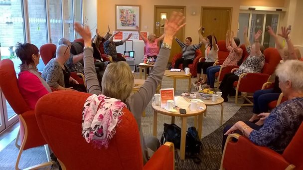 adults participating in chair dancing