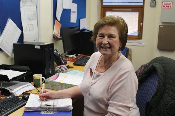 Photo of Barnsley Hospice volunteer Jean seated at a desk
