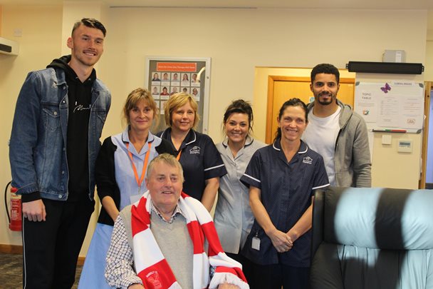 Kieffer and Zeki with hospice staff and a patient