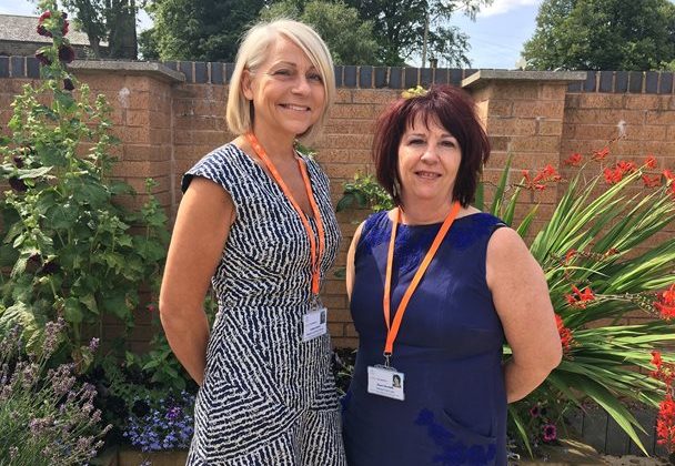 A photo of two ladies standing outside in the Barnsley Hospice garden.
