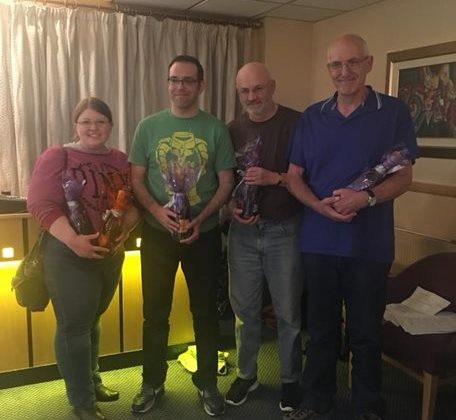 Photo of four participants at the Yorkshire Bank quiz night. The group are holding the prizes they have won.