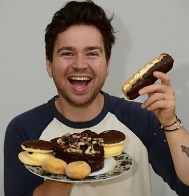 Sam Nixon with plate of cakes