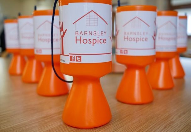 Image of a selection of Barnsley Hospice collecting boxes on a table