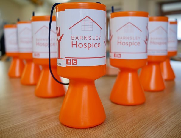 Image of a selection of Barnsley Hospice collecting boxes on a table