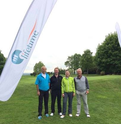 Photo from the Barnsley Hospice golf day. Four people are standing on the golf course.