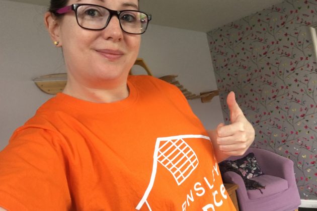 Photo of a lady wearing an orange coloured Barnsley Hospice t-shirt and doing a thumbs up sign