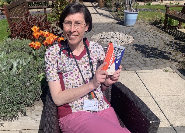 Photo of Dr Becky Hirst holding the book; Letters from Lockdown.