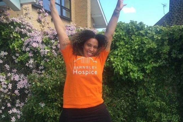 woman wearing Hospice t-shirt leaping into the air