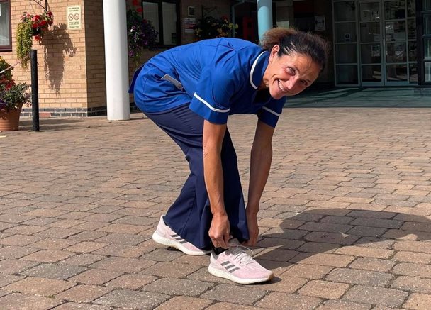 Photo of Zoe fastening the lace on her running shoes