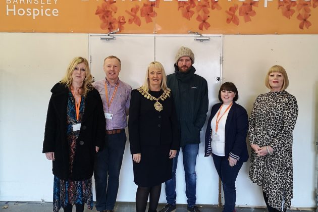 A group photo of Barnsley Hospice staff and the Mayor of Barnsley who is visiting the Hospice Retail Hub.