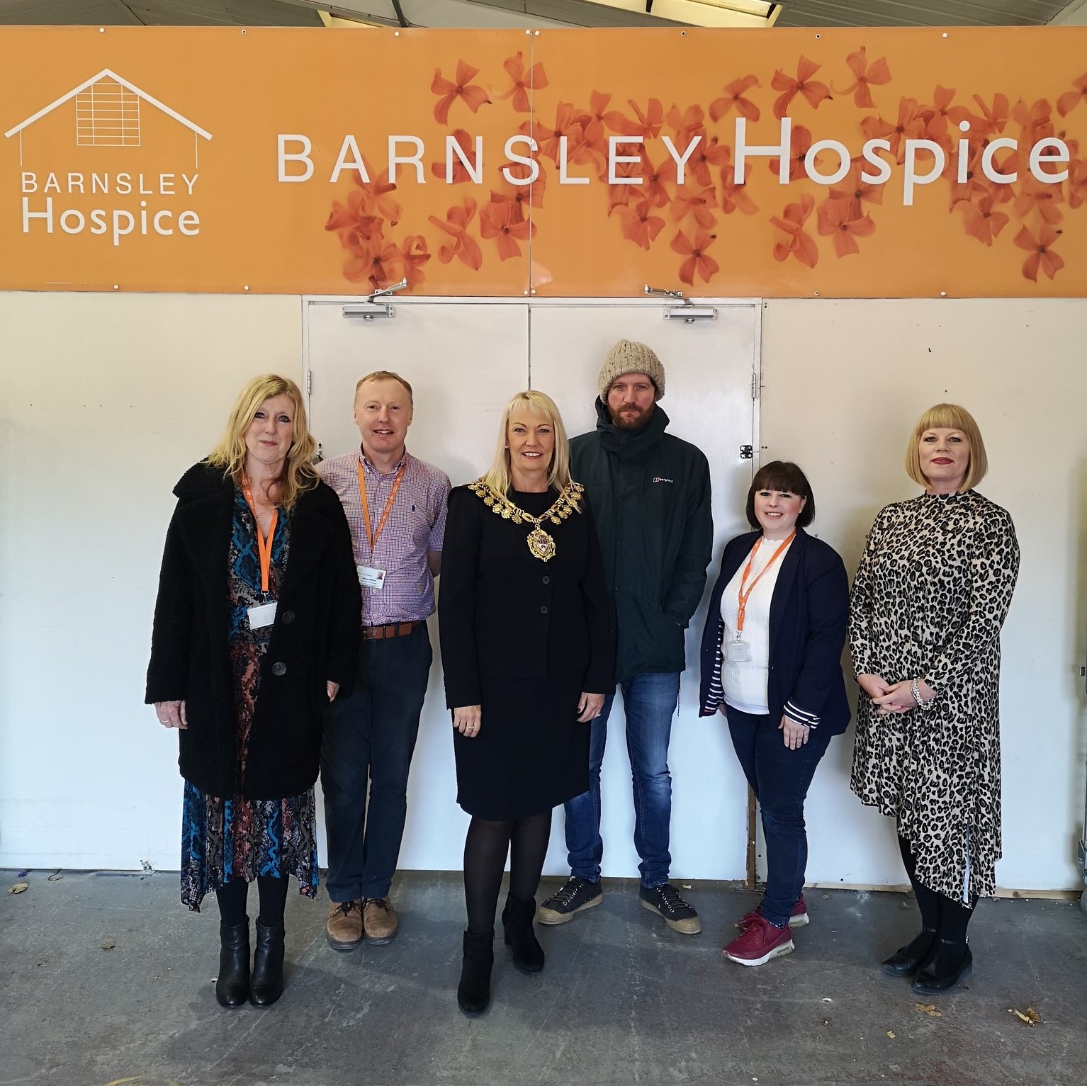 A group photo of Barnsley Hospice staff and the Mayor of Barnsley who is visiting the Hospice Retail Hub.