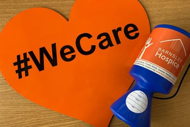 Photo of a heart shaped We Care sign and a Barnsley Hospice collection box