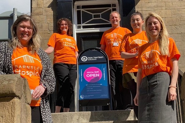 Photo of the team form Icon Harrison Solicitors outside their office. The team are wearing orange Barnsley Hospice t-shirts.