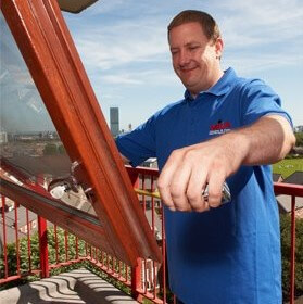 Photo of man from Mila measuring a window