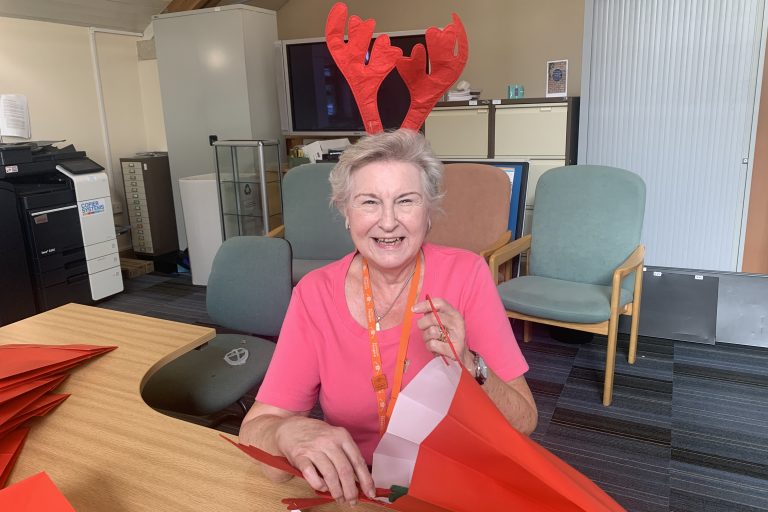 A photo of a hospice volunteer helping out at the Rudolph run fundraising event.