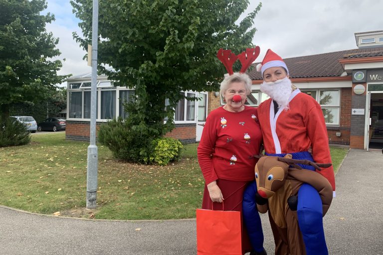 Photo of two ladies dressed in festive outfits to promote the Rudolph fun run