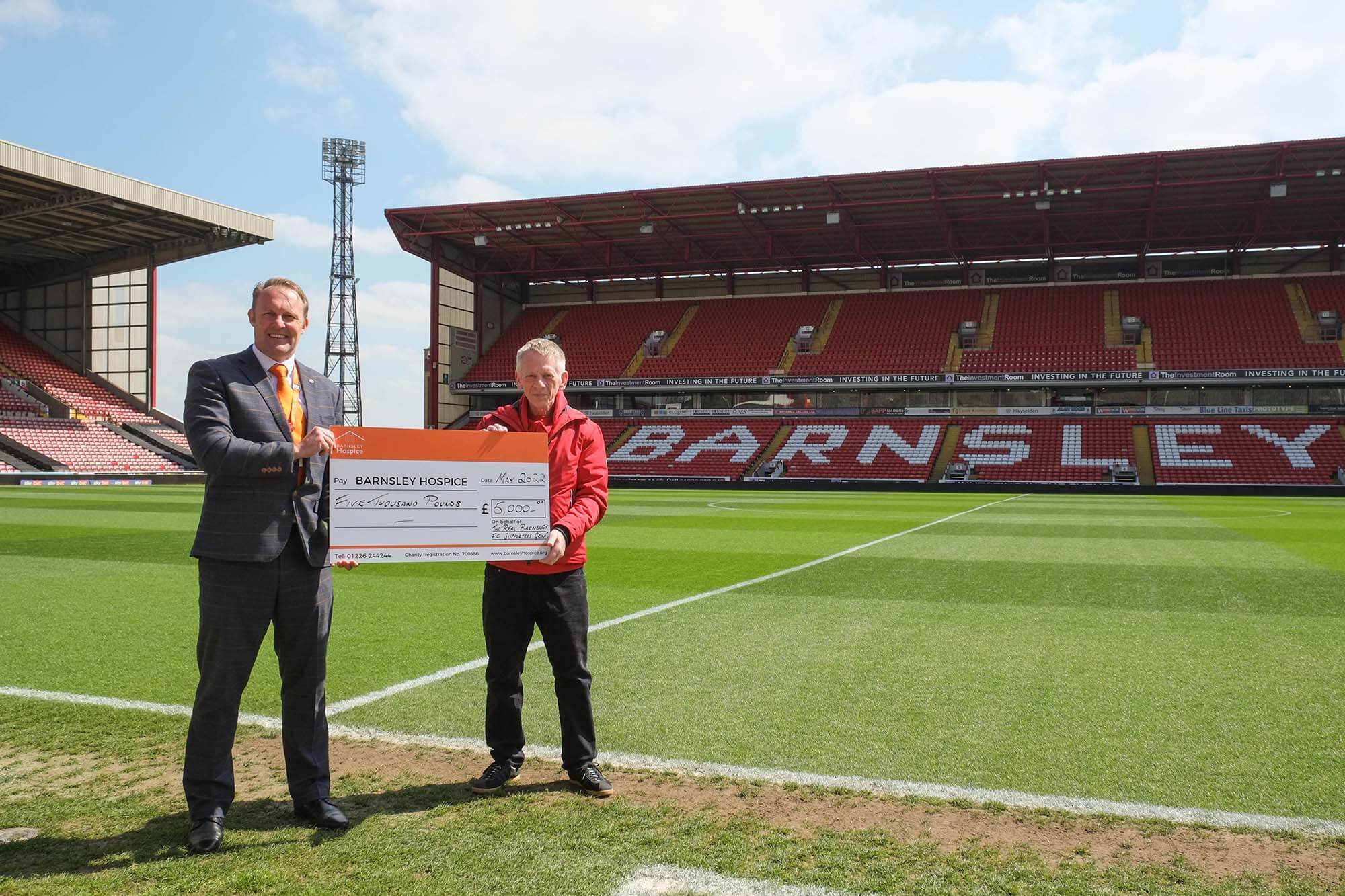 Photo of Simon Atkinson and Mark Oldfield holding a donation cheque for Barnsley Hospice