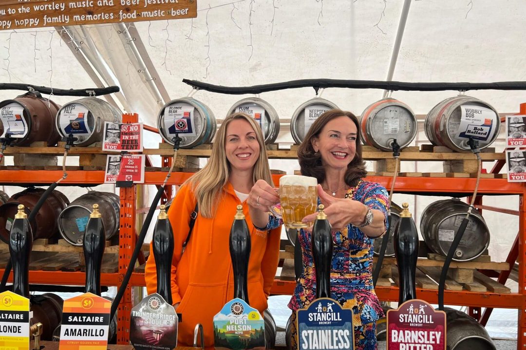 Lady Rowena and Vicky Stead smiling behind the bar