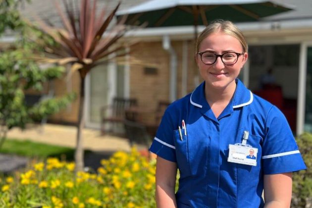 Photo of a member of the nursing team standing outside Barnsley Hospice.