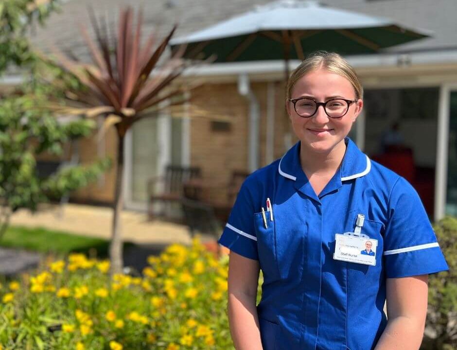 Photo of a member of the nursing team standing outside Barnsley Hospice.