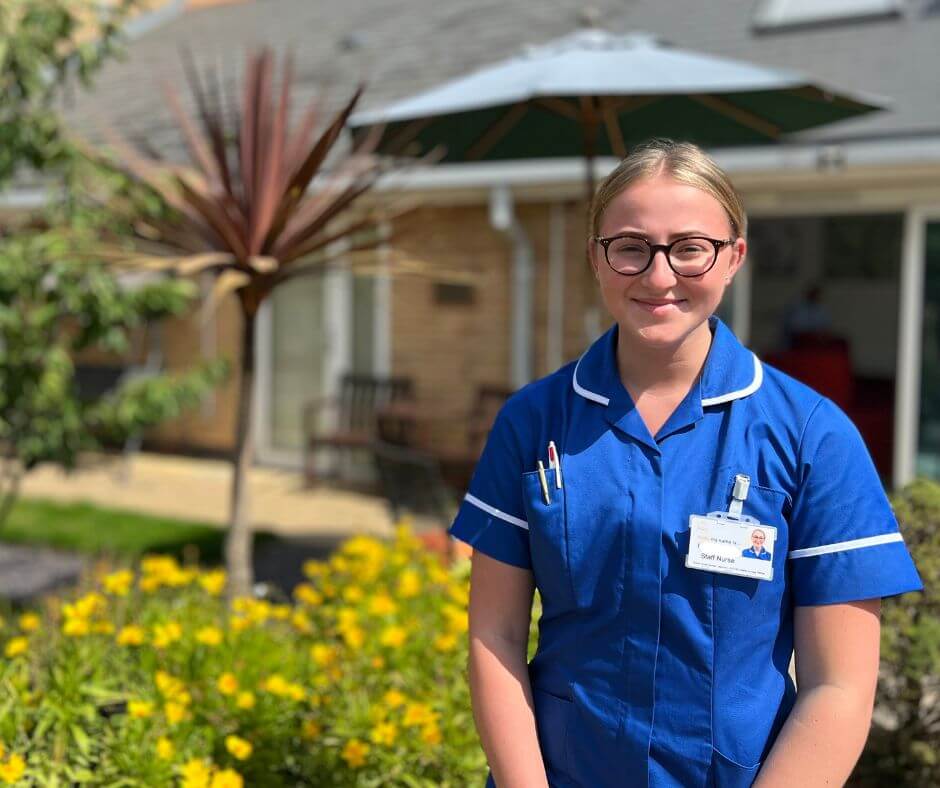 Photo of a member of the nursing team standing outside Barnsley Hospice.
