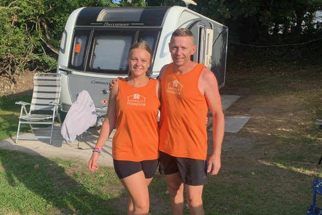 Photo of Amy and her dad Ian, wearing orange Barnsley Hospice running vests.