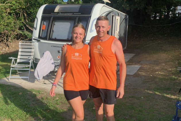 Photo of Amy and her dad Ian, wearing orange Barnsley Hospice running vests.