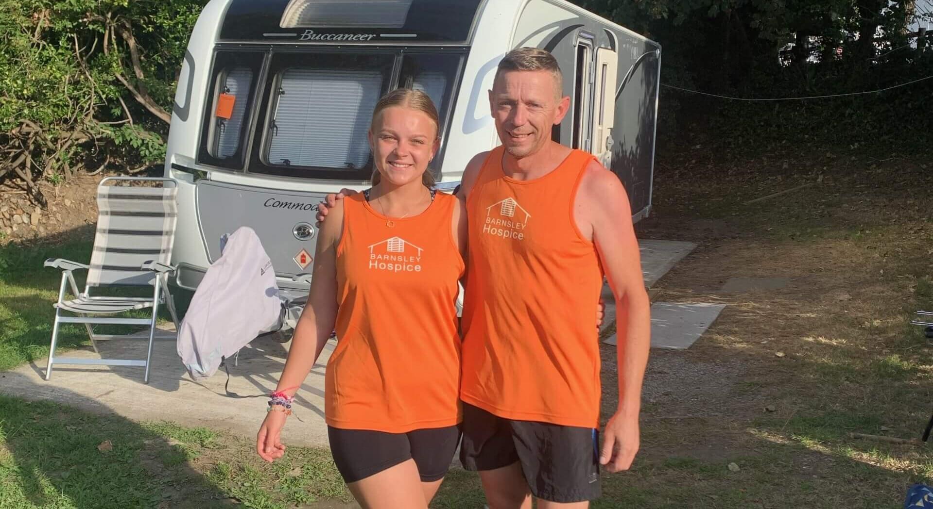 Photo of Amy and her dad Ian, wearing orange Barnsley Hospice running vests.