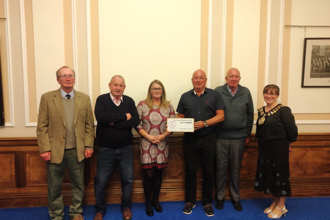 Photo of Barnsley Hospice volunteer gardens receiving a gold award certificate from the Mayor of Barnsley