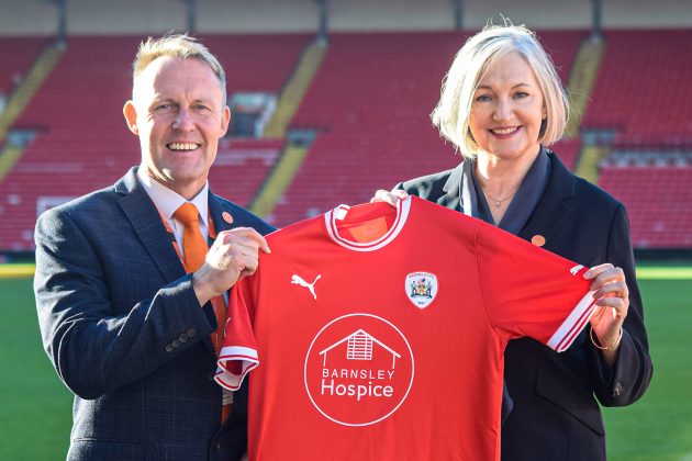 Barnsley Hospice logo on Barnsley Football Club top being held by Hospice staff