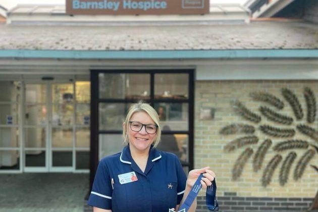 Mel Butcher with her Cavell Star award outside the hospice entrance