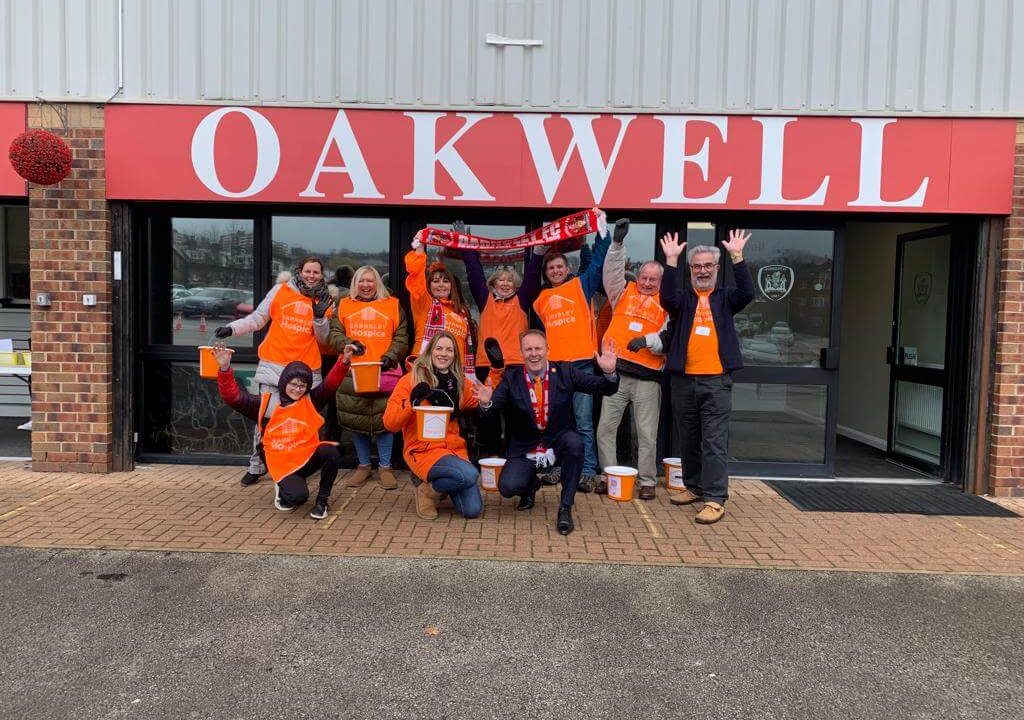 Hospice volunteers wearing tabards at Oakwell football ground entrance
